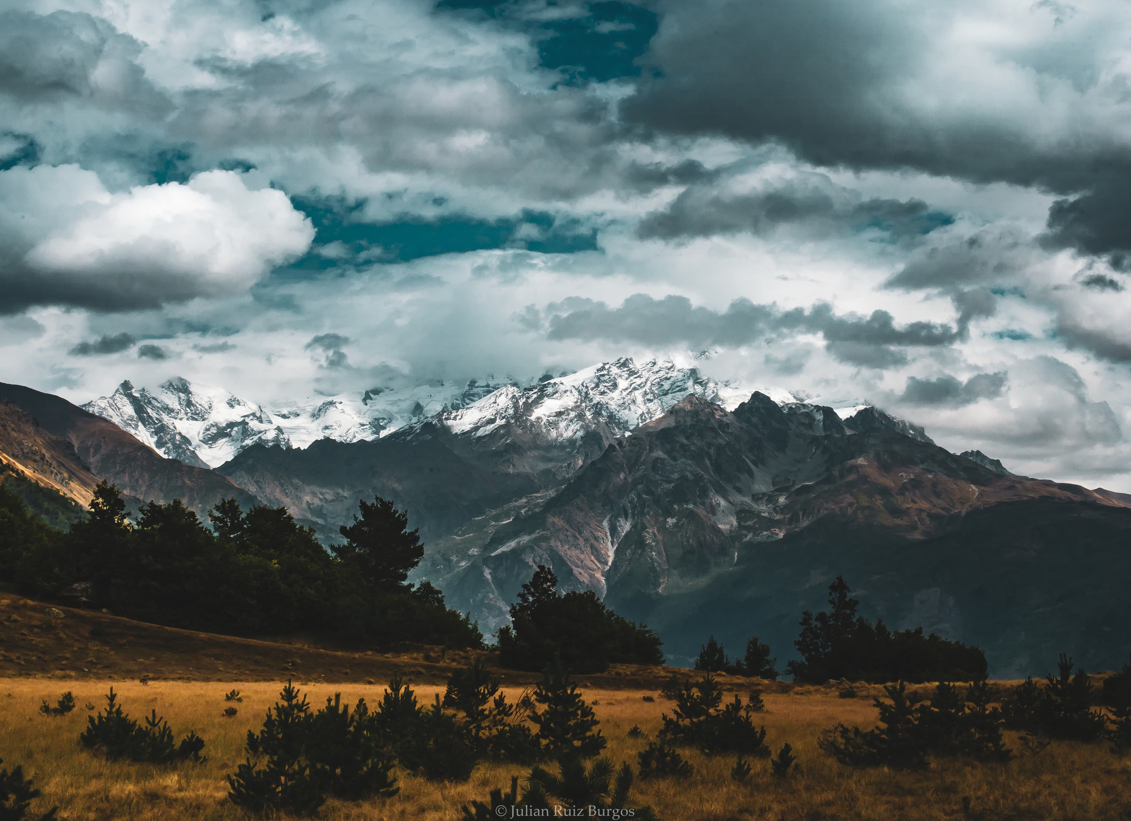 Storm Light Over Snow Capped Peaks