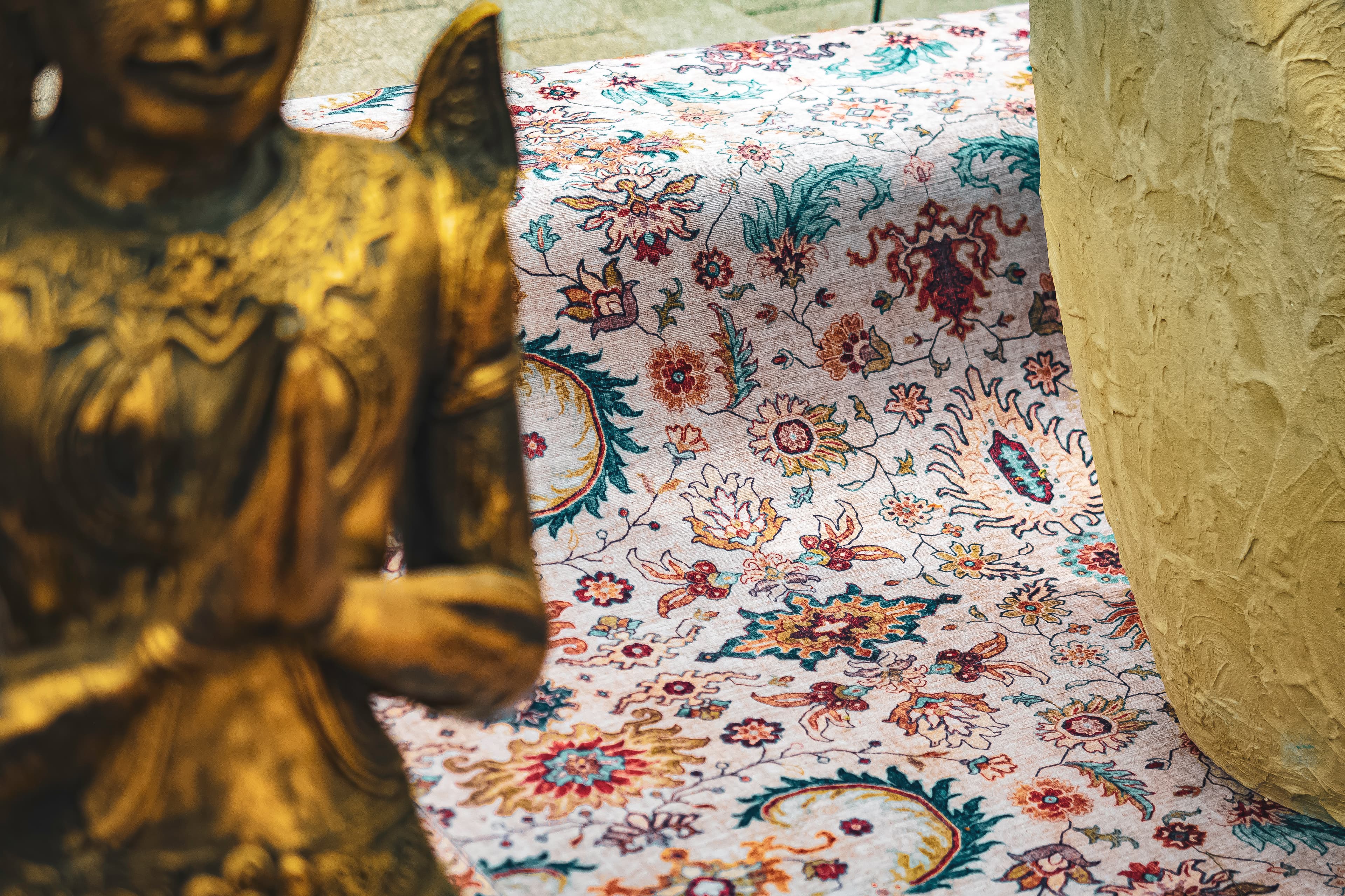 Golden Buddha Beside a Persian Rug