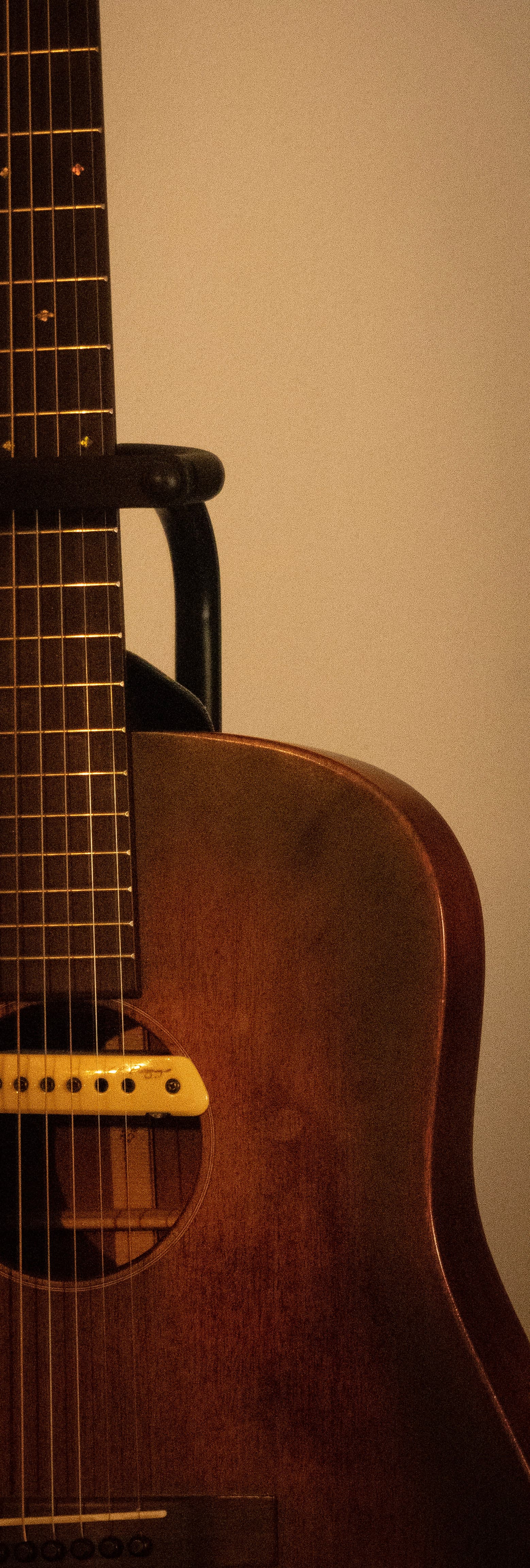 Weathered Guitar Resting in Warm Shadow