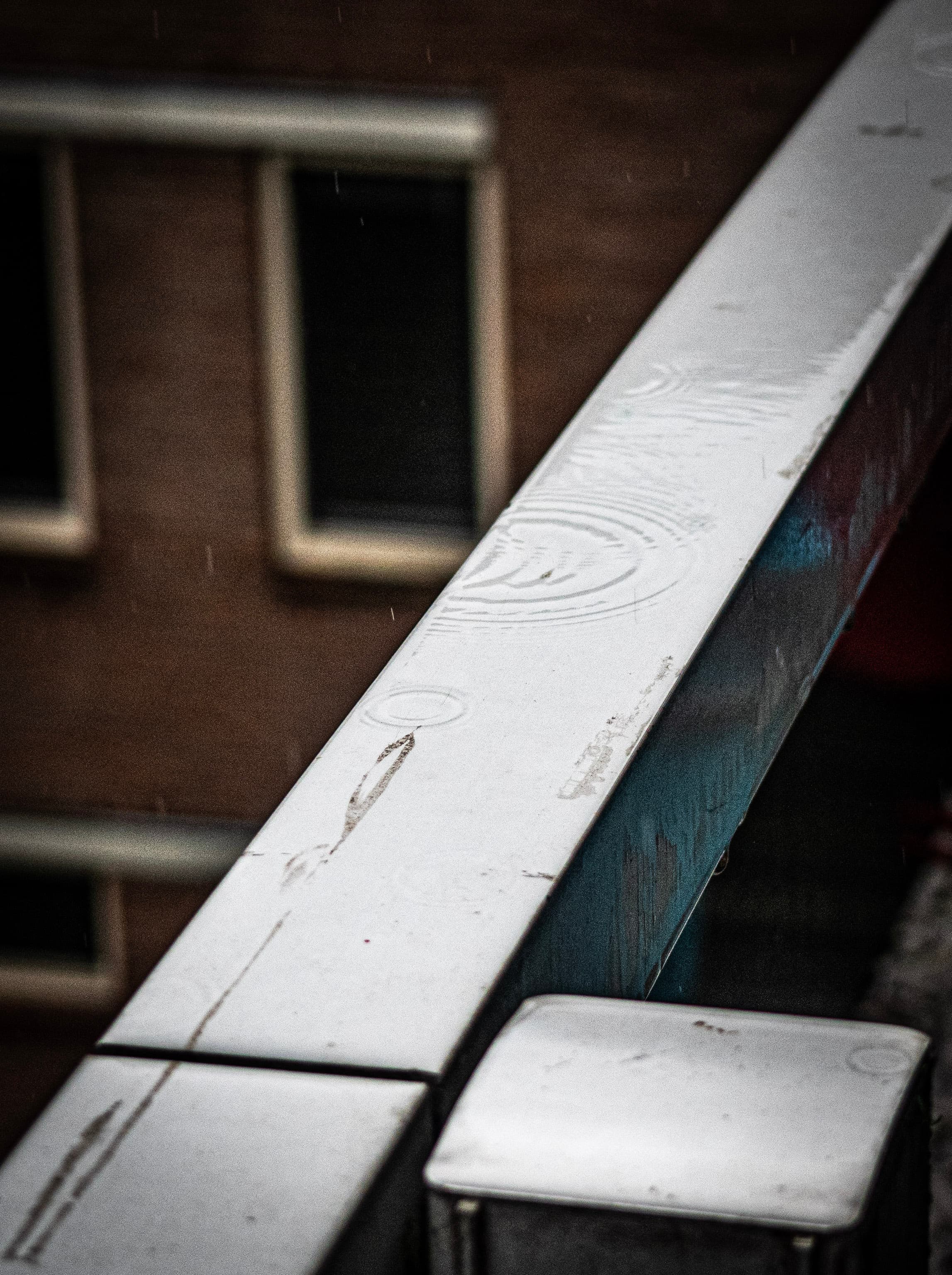 Rain Ripples on Weathered White Rail
